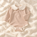 The Sailor Stripe Cotton Romper — khaki-B studio flat lay on warm ivory linen