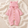 The Bear Ear Knit Baby Romper — Style 01 studio flat lay on warm ivory linen