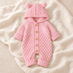 The Bear Ear Knit Baby Romper — Style 01 studio flat lay on warm ivory linen