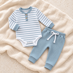 The Stripe Romper & Trouser Set — Style 02 studio flat lay on warm ivory linen
