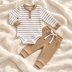 The Stripe Romper & Trouser Set — Style 04 studio flat lay on warm ivory linen