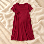 Short-Sleeve Maternity Nursing Nightdress in Red, photographed on warm cream linen