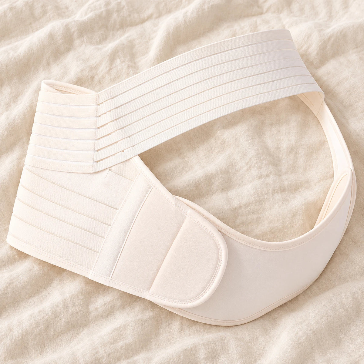 Tots & Moms adjustable pregnancy support belt — M / White — product on cream linen
