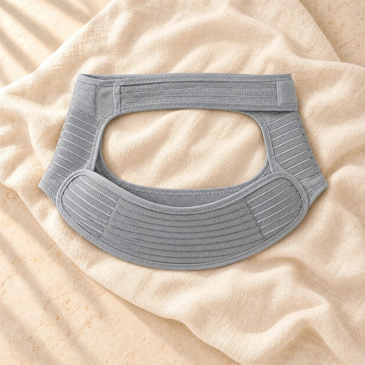 Adjustable Maternity Abdominal Support Belt, Light Grey, product on cream linen