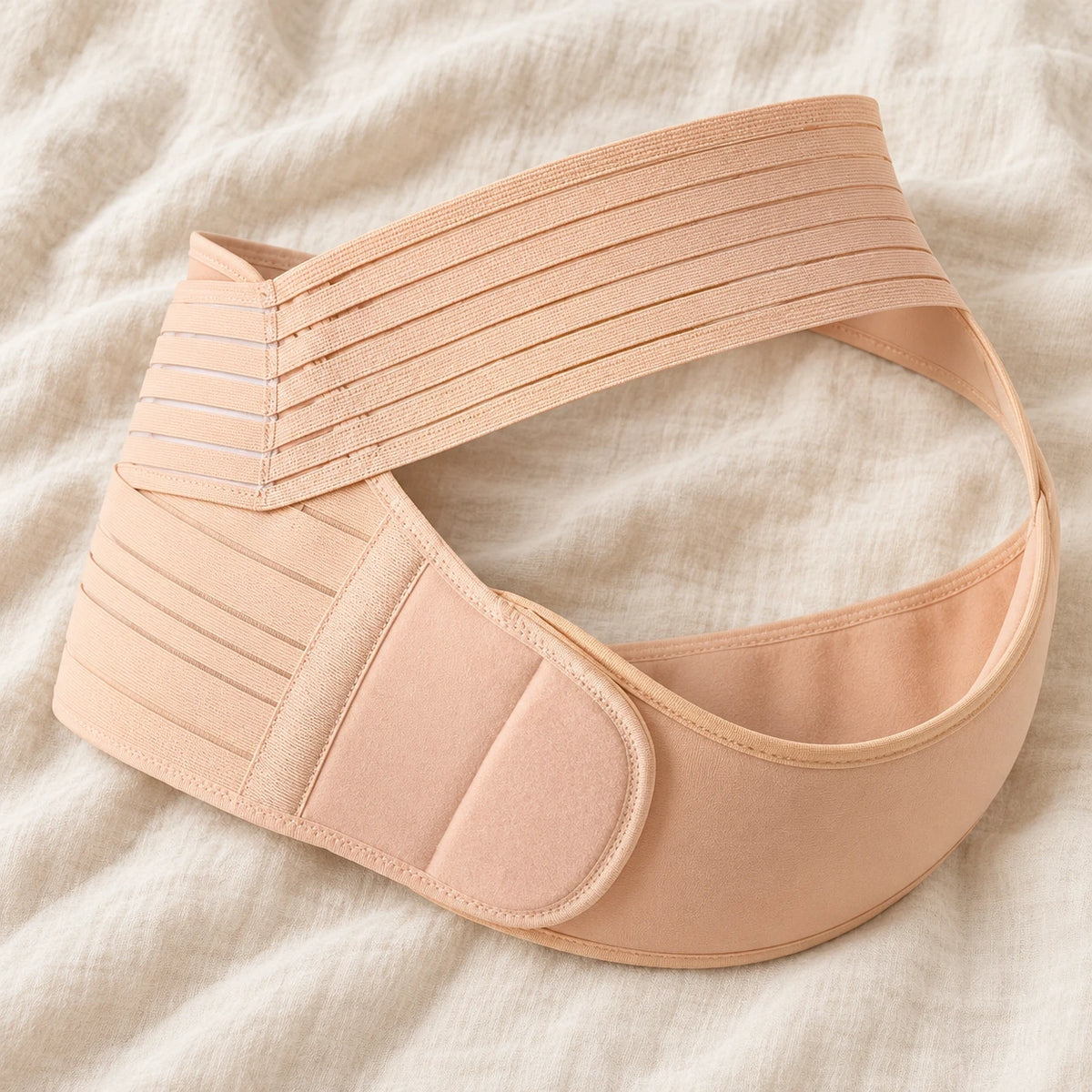 Tots & Moms adjustable pregnancy support belt — M / Nude — product on cream linen