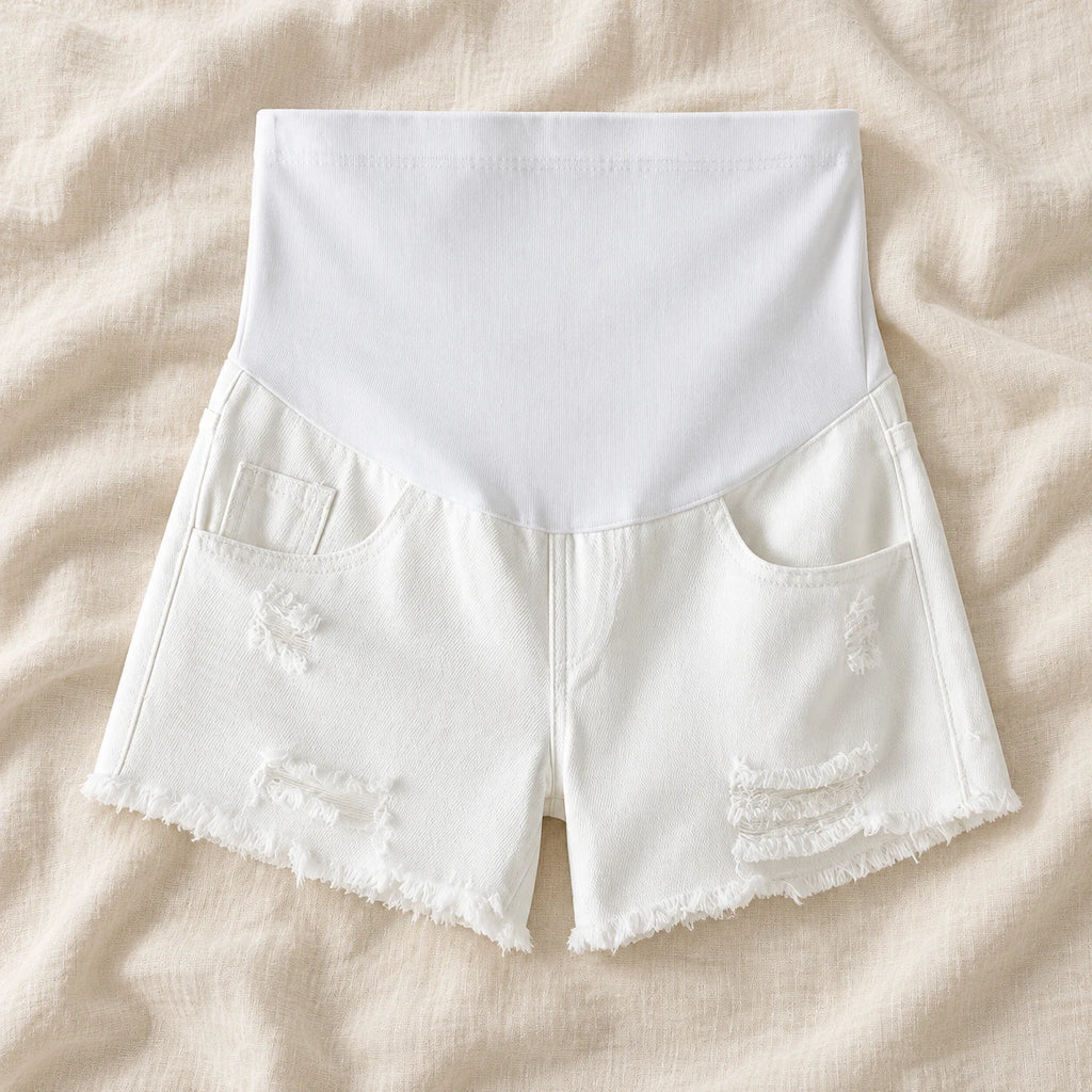 Distressed Maternity Denim Shorts — Style White — full belly panel — on cream linen