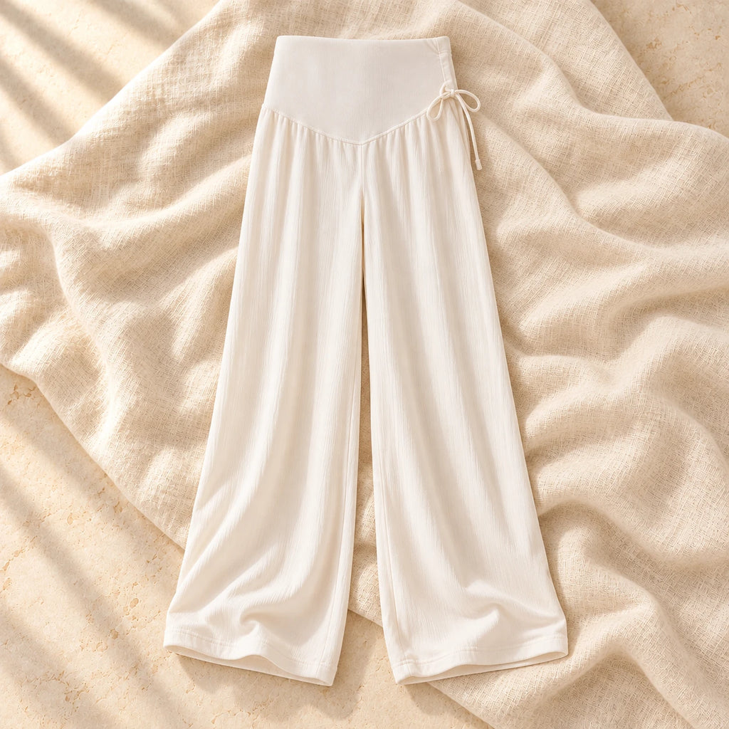 Drawstring Wide-Leg Maternity Trousers in Apricot, photographed on warm cream linen