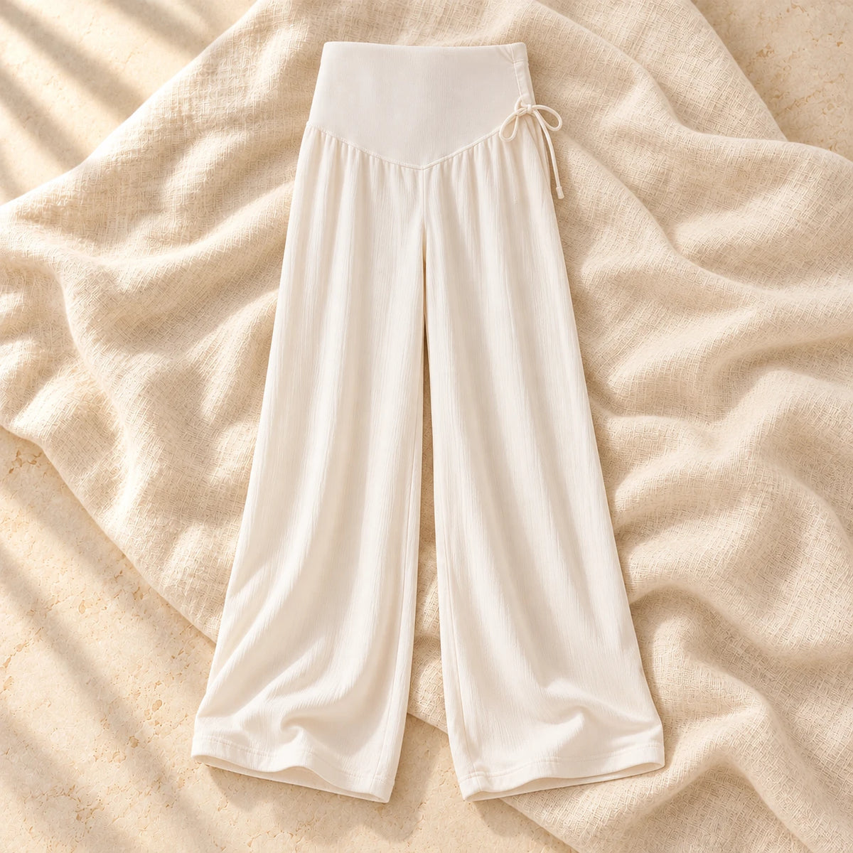 Drawstring Wide-Leg Maternity Trousers in Apricot, photographed on warm cream linen