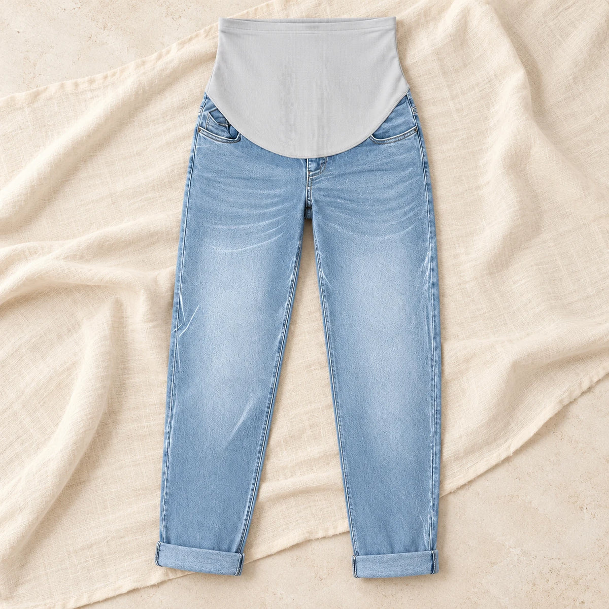 Over-Bump Relaxed Maternity Jeans — Light blue, product on cream linen