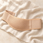 Beige prenatal belly support belt, product on cream linen