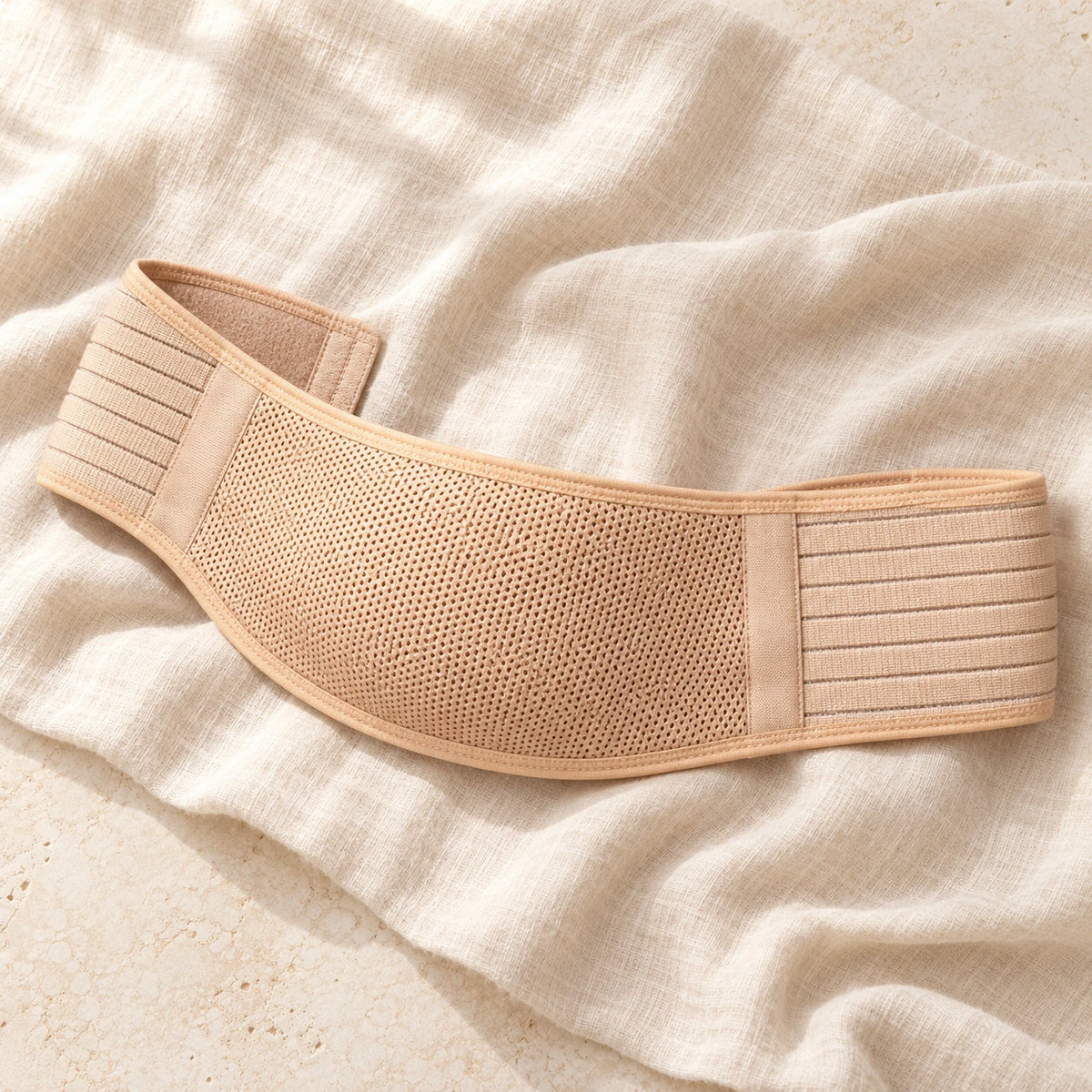 Beige prenatal belly support belt, product on cream linen