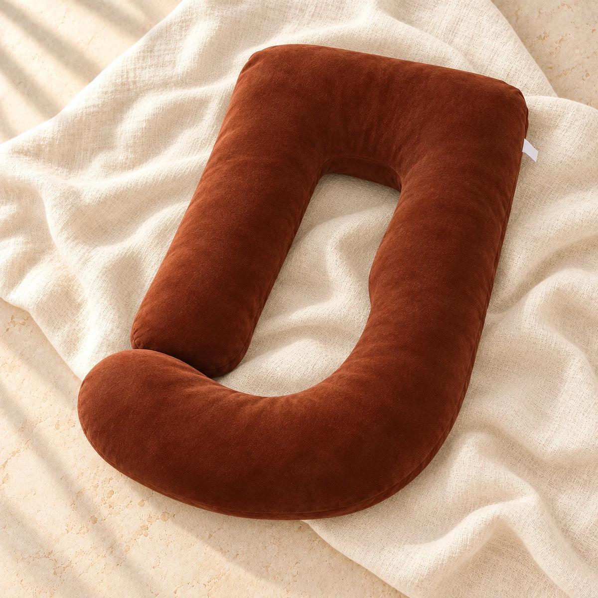 Full-Body Pregnancy Pillow with Washable Cover, Dark Brown, on warm cream linen