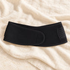 Maternity Waist Support Band — Black, photographed on cream linen