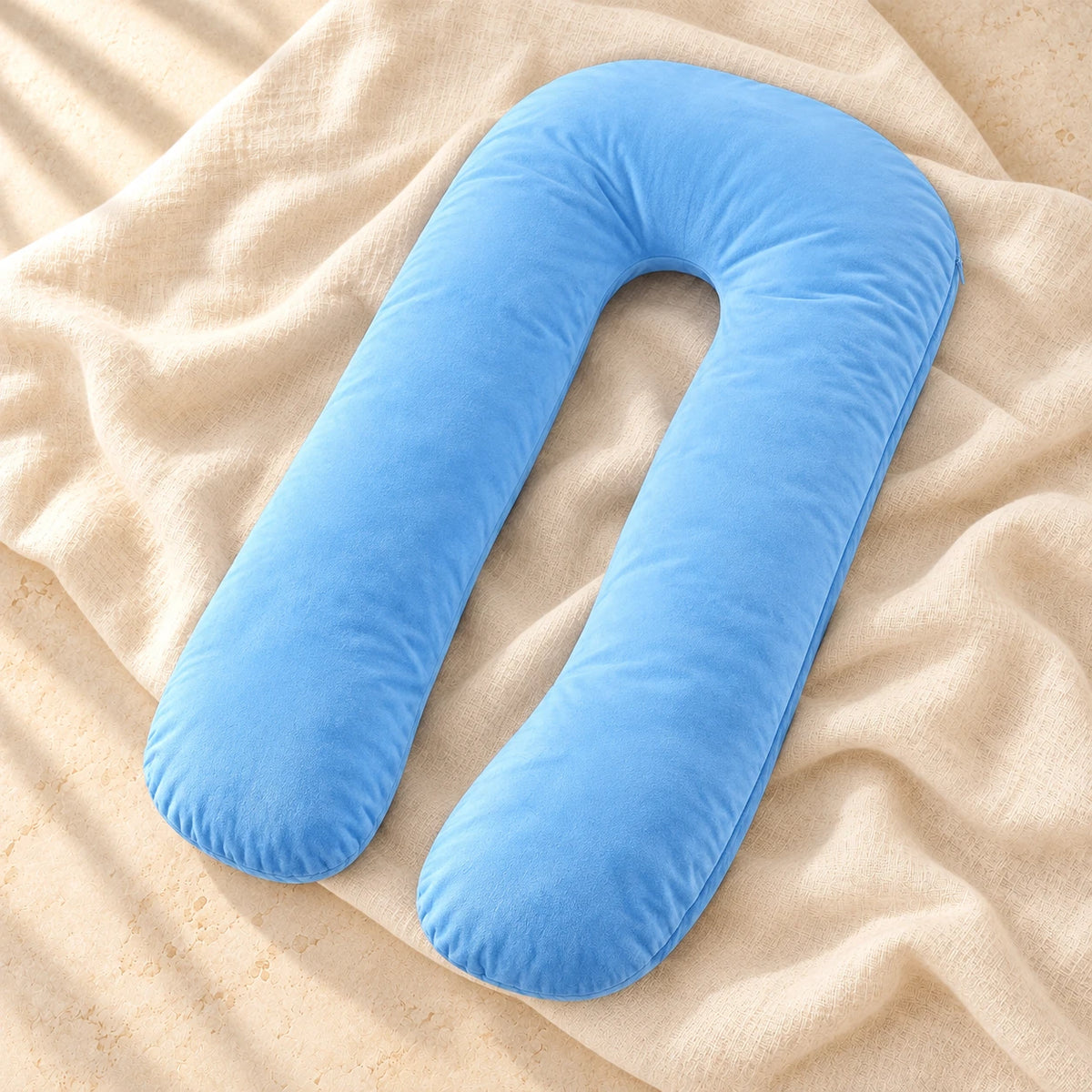 Light Blue U-shaped pregnancy pillow on warm cream linen