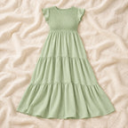 Sleeveless Tiered Maternity Dress — Light Green — on cream linen