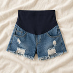 Distressed Maternity Denim Shorts — Style Dark Blue — full belly panel — on cream linen