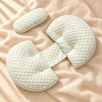 Adjustable Side-Sleeping Pregnancy Wedge Pillow in green, photographed on warm cream linen