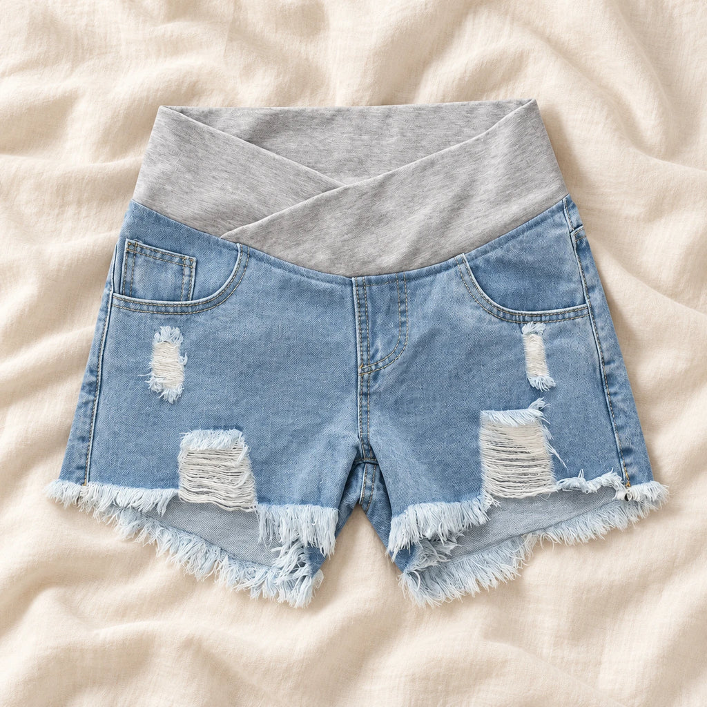 Distressed Maternity Denim Shorts — Style Light Blue — crossover waist — on cream linen