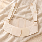 Beige maternity support belt with shoulder straps, product on cream linen