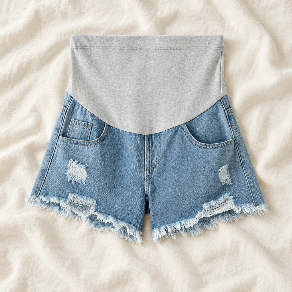 Distressed Maternity Denim Shorts — Style Light Blue — full belly panel — on cream linen