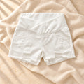 Low-Rise Maternity Denim Shorts, White — crossover waist, on warm cream linen