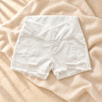 Low-Rise Maternity Denim Shorts, White — crossover waist, on warm cream linen