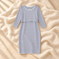 Striped Three-Quarter Sleeve Nursing Dress in WHITE, photographed on warm cream linen