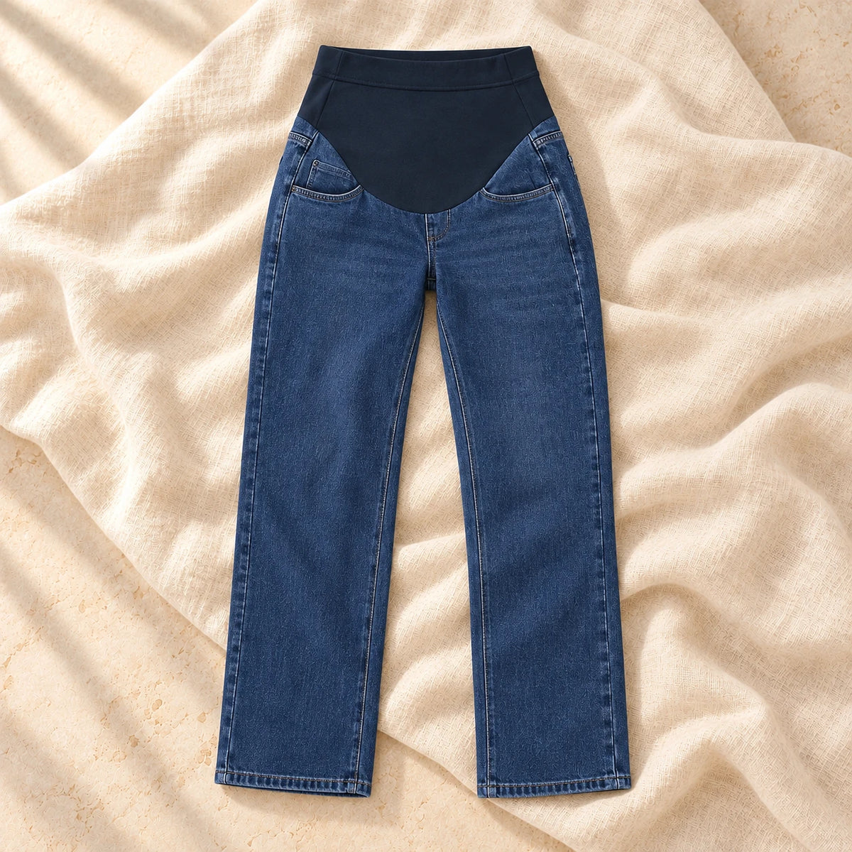 Adjustable-Waist Wide-Leg Maternity Jeans in Dark Blue, photographed on warm cream linen