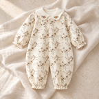 Cream botanical baby romper with delicate brown sprig print on ivory linen