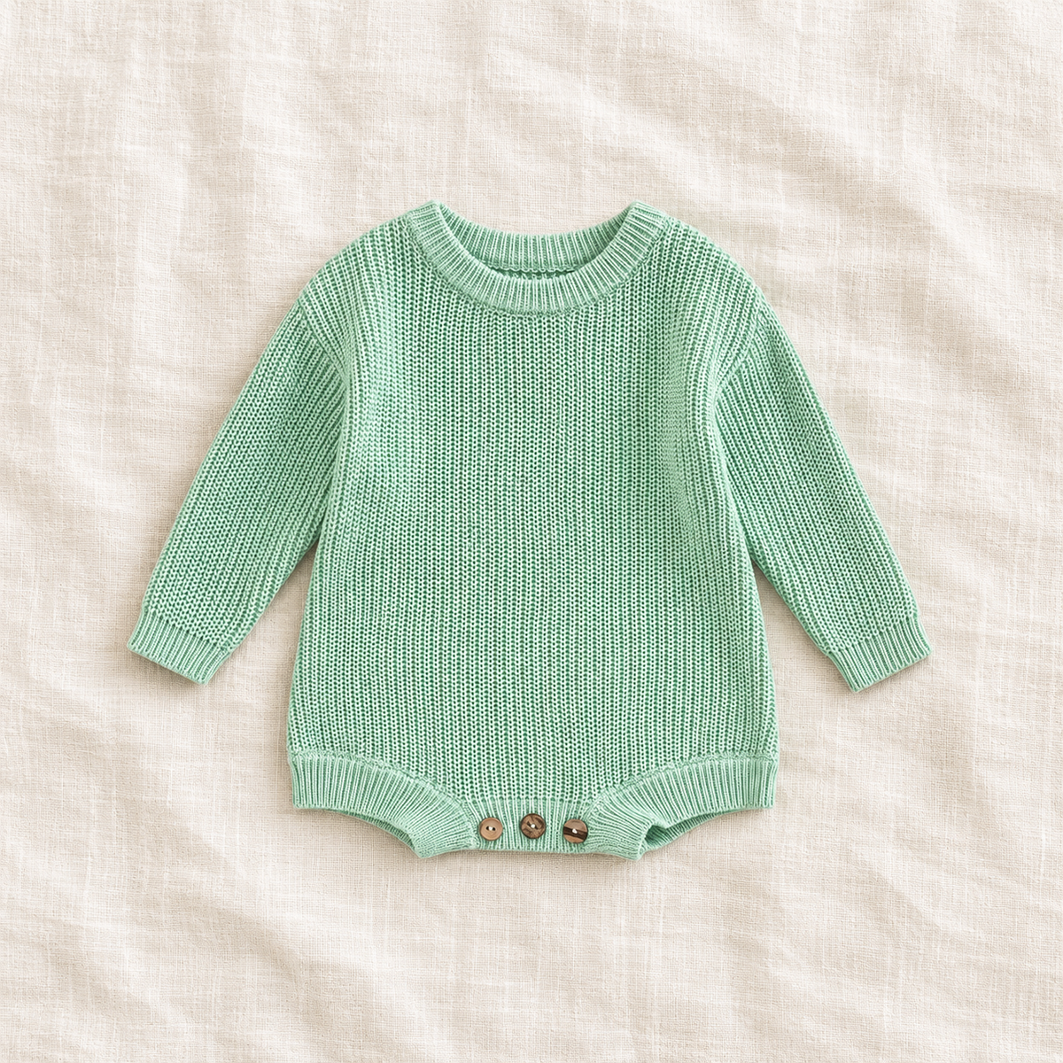 Button knit baby romper in Light Green, boutique studio photograph