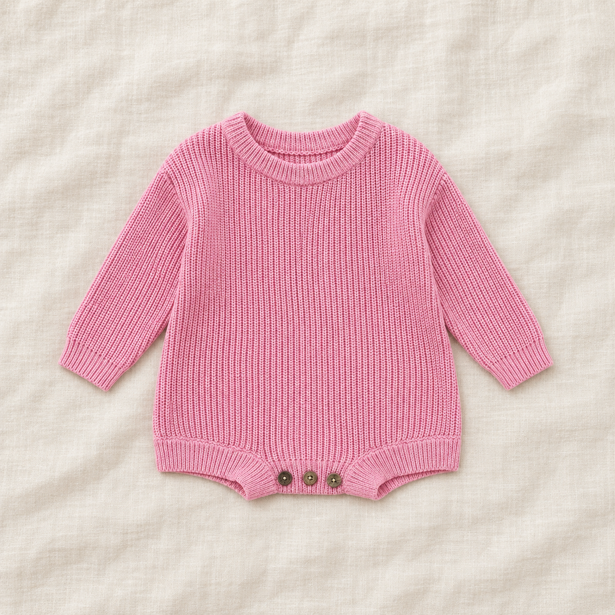 Button knit baby romper in Pastel Pink, boutique studio photograph