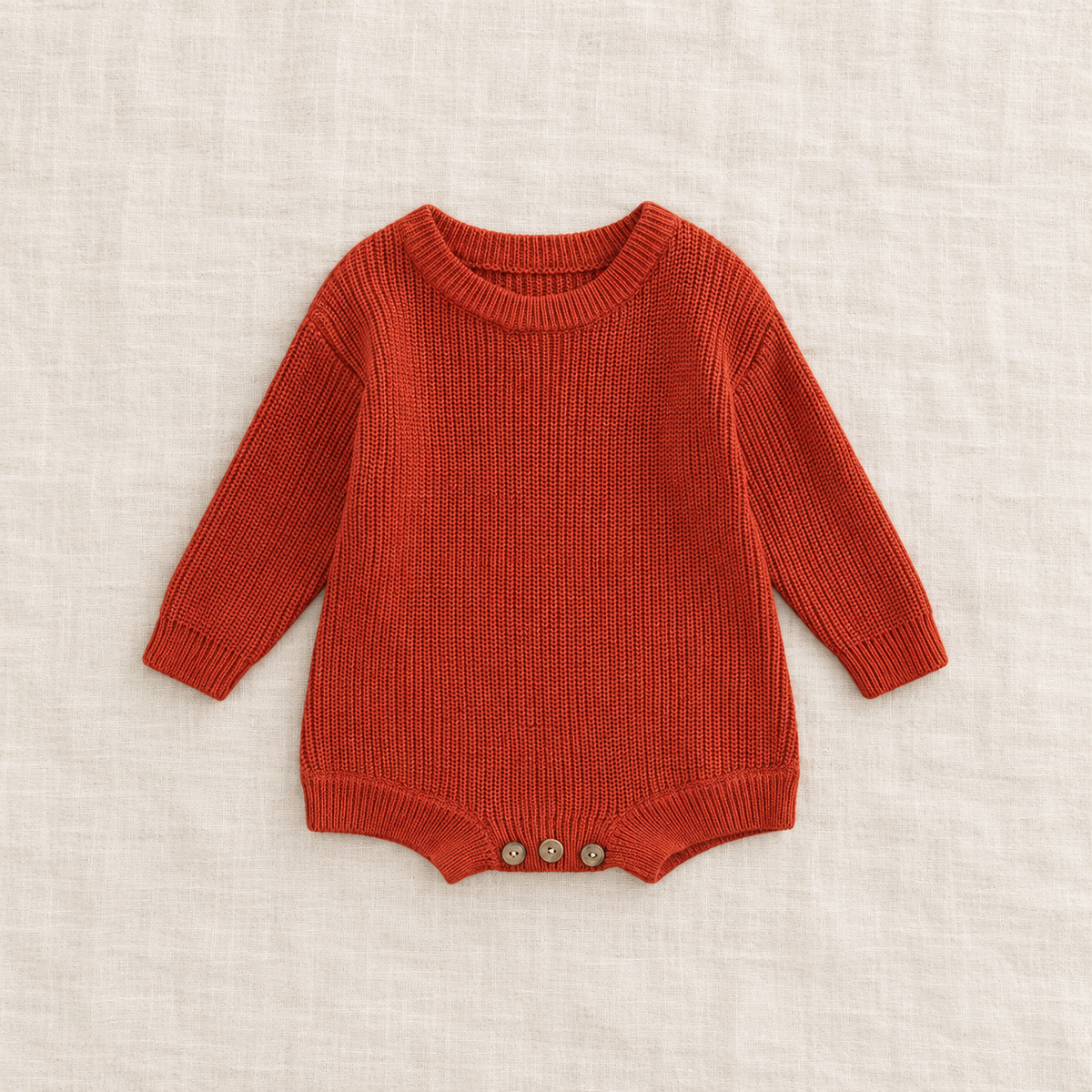 Button knit baby romper in Brick Red, boutique studio photograph