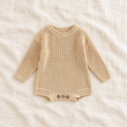 Button knit baby romper in Beige, boutique studio photograph