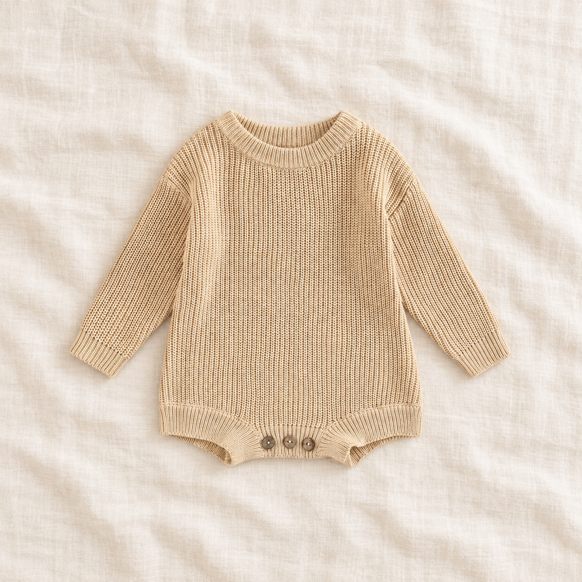 Button knit baby romper in Beige, boutique studio photograph