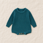 Button knit baby romper in Bluish Green, boutique studio photograph