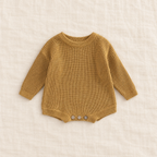 Button knit baby romper in Dark beige, boutique studio photograph