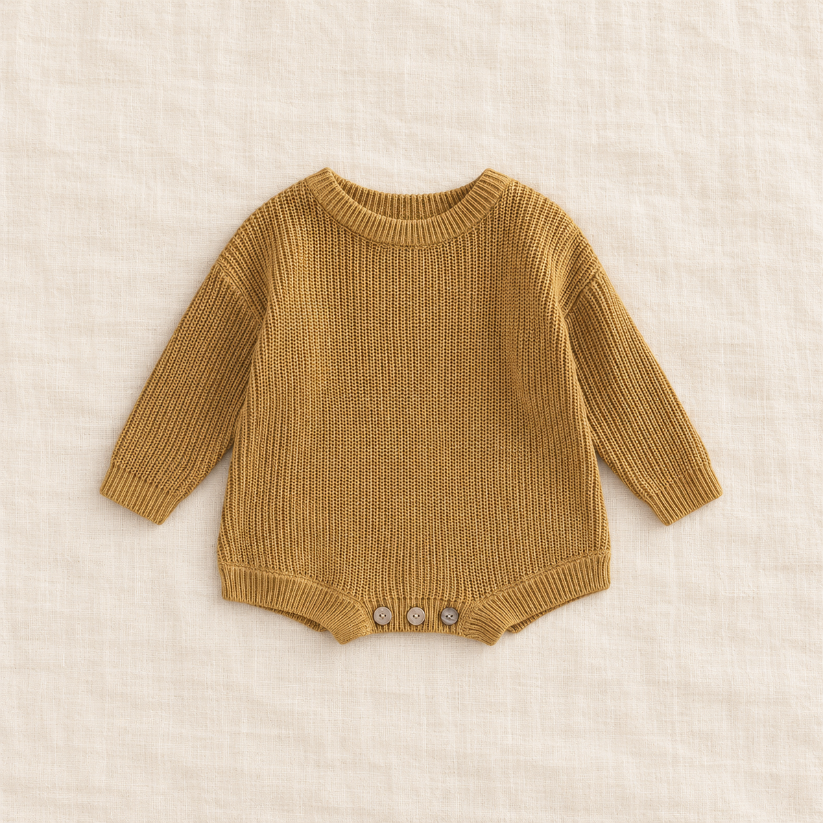 Button knit baby romper in Dark beige, boutique studio photograph