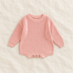 Button knit baby romper in Pink, boutique studio photograph