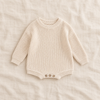 Button knit baby romper in Light Milk White, boutique studio photograph