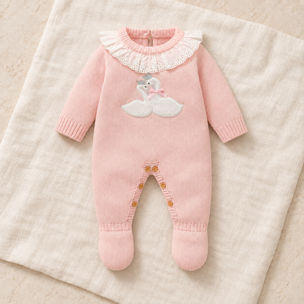 Blush pink goose knit footed baby romper on ivory linen