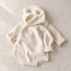 The Bear-Ear Hooded Knit Bodysuit on ivory linen