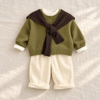 Green button knit cardigan and coordinating trousers, styled with a brown scarf