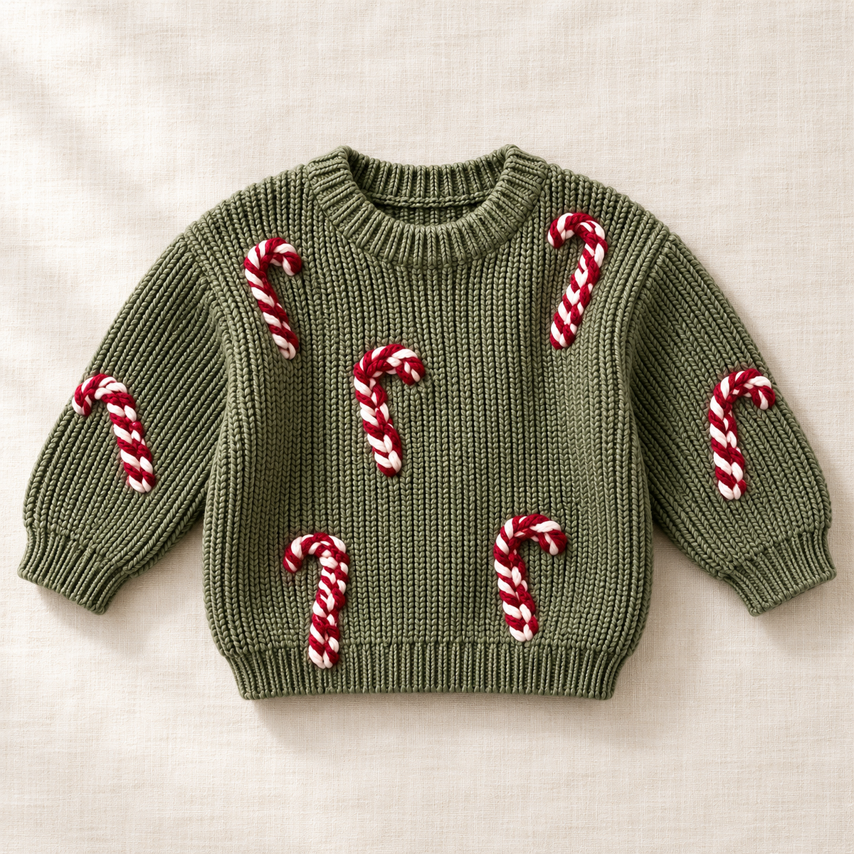 The Candy Cane Knit Sweater on ivory linen