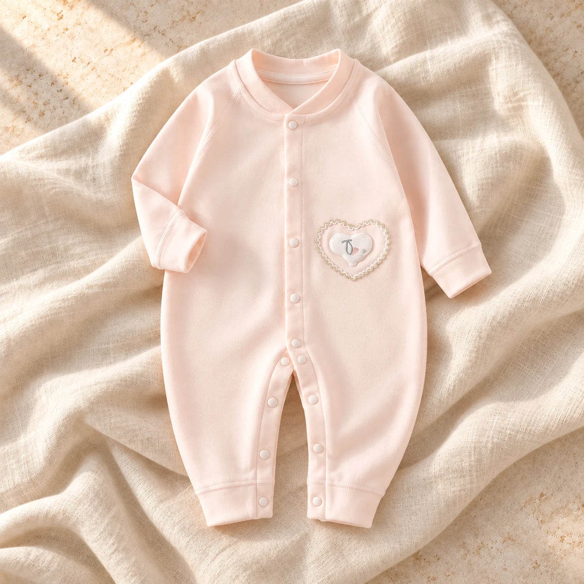 The Printed Cotton Baby Romper — Pink Elephant — studio product photograph