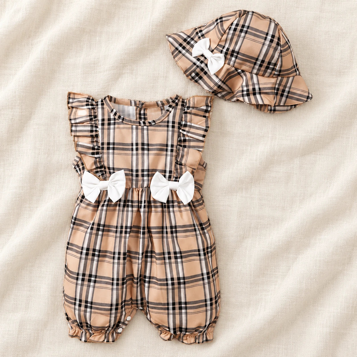 The Gingham Bow Romper & Hat Set — Tan Check & White Bows — studio product photograph