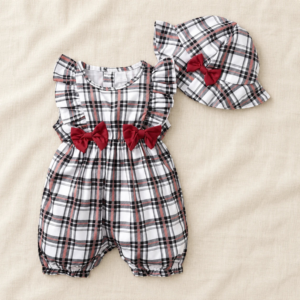 The Gingham Bow Romper & Hat Set — Black Check & Red Bows — studio product photograph