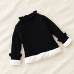 The Fleece-Lined Ruffle Knit Sweater — Black — studio product photograph