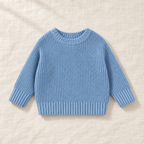 The Everyday Chunky Knit Sweater in Blue, laid flat on ivory linen