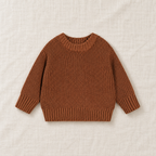 The Everyday Chunky Knit Sweater in Brown, laid flat on ivory linen