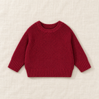 The Everyday Chunky Knit Sweater in Burgundy, laid flat on ivory linen
